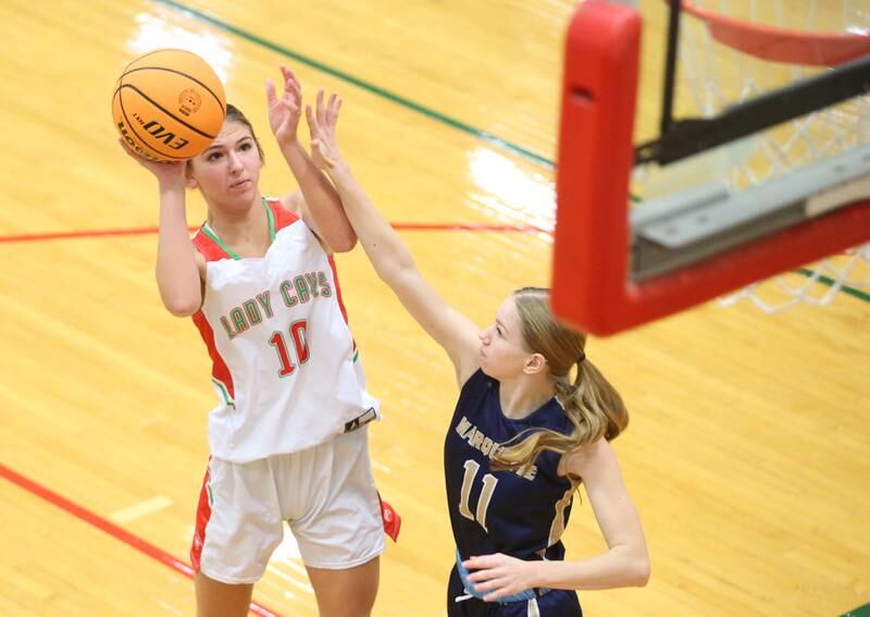 L-P's Kelsey Frederick eyes the hoop while being guarded by Marquette's Keely Nelson on Saturday, Jan. 4, 2025 in Sellett Gymnasium at L-P High School.
