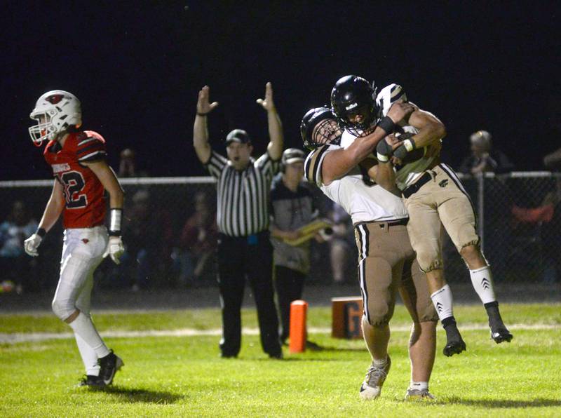 Lena-Winslow's Alec Schlichting gets a hug from a lineman after scoring a touchdown against Forreston on  Friday, Aug, 29, 2025 at Forreston High School.