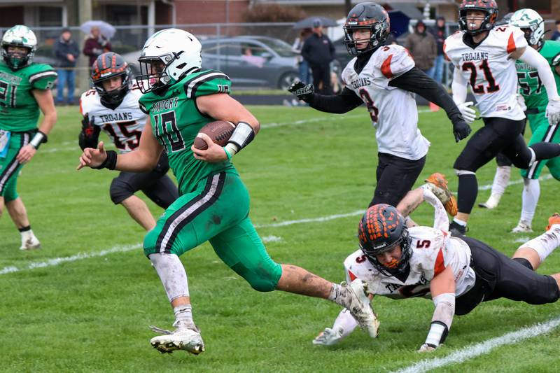 Dwight/Gardner-South Wilmington's Evan Cox (10) gets past Elmwood-Brimfield would-be-tackler Layne Johnson (5) and runs for the first touchdown of their Class 2A playoff game Saturday, Nov. 9, 2024, at in Dwight.
