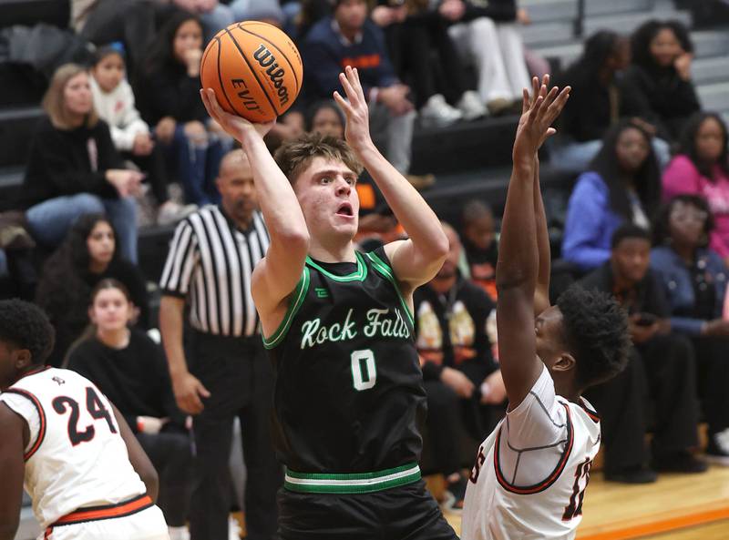 Rock Falls' Max Burns shoots over DeKalb's Derrion Straughter during their game Tuesday, Dec. 2, 2025, at DeKalb High School.