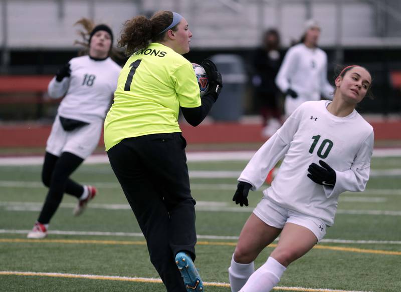 Schaumburg's Sophia Dietz reels in a shot before Crystal Lake South's Bella Farrington can get to it during girls soccer action Saturday, March 26, 2022 in Schaumburg.