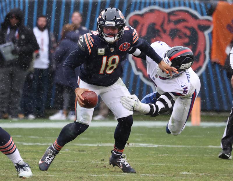 Chicago Bears quarterback Caleb Williams escapes New York Giants linebacker Kayvon Thibodeaux Sunday, Nov. 9, 2025, during their game at Soldier Field in Chicago.