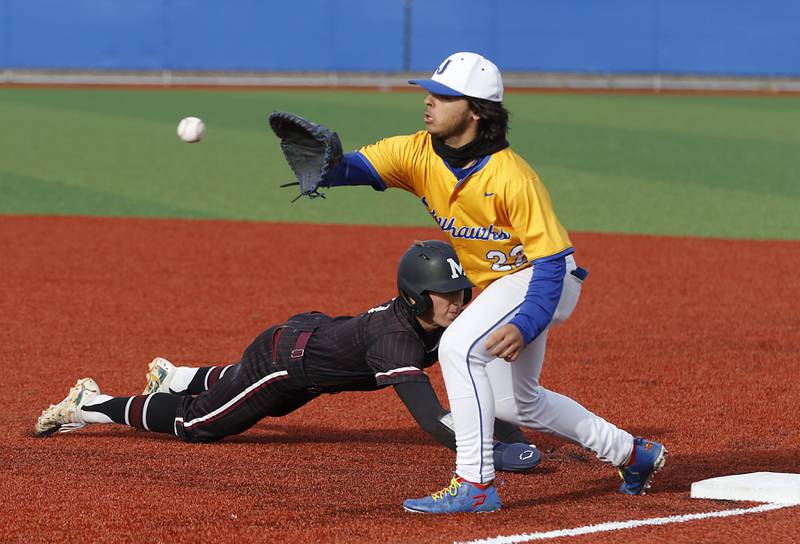 Marengo's Alten Bergbreiter dives back to first base in front of the throw to Johnsburg's Dom Vallone during a Kishwaukee River Conference baseball game on Monday, April 21, 2025, at Johnsburg High School.