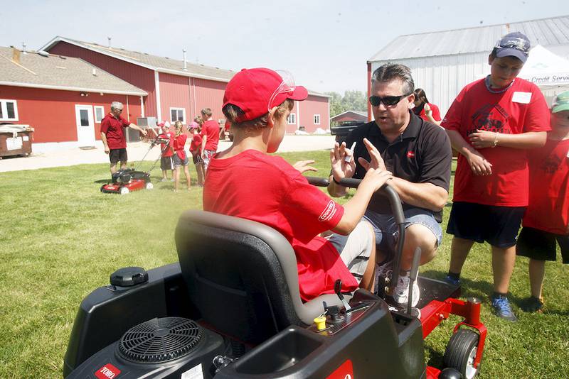 Tom Newquist of DeKalb Lawn & Equipment Co. explains the proper way to steer a Toro riding lawnmower at the DeKalb County Farm Bureau Farm Safety Camp at Jonamac Orchard on June 27.