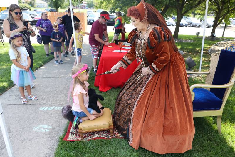 Jan Stack, clerk for Youth Services, knights Kaylee Hoffman a Queen Anne of Librarium at the Royal Faire hosted by the Joliet Public Library Black Road Branch on Saturday, July 22nd, 2023.