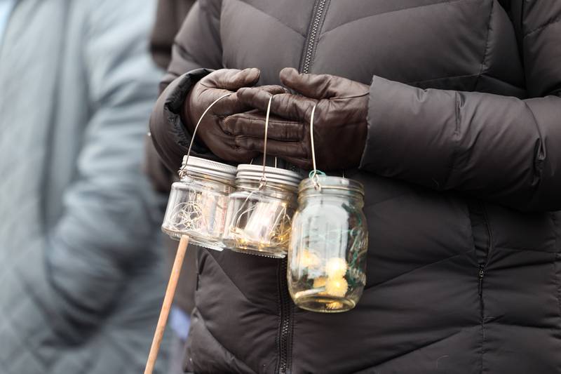 An attendee holds lights in vigil during an ICE Out for Good protest and vigil at The Grow Center in Bourbonnais on Sunday, Jan. 11, 2026.