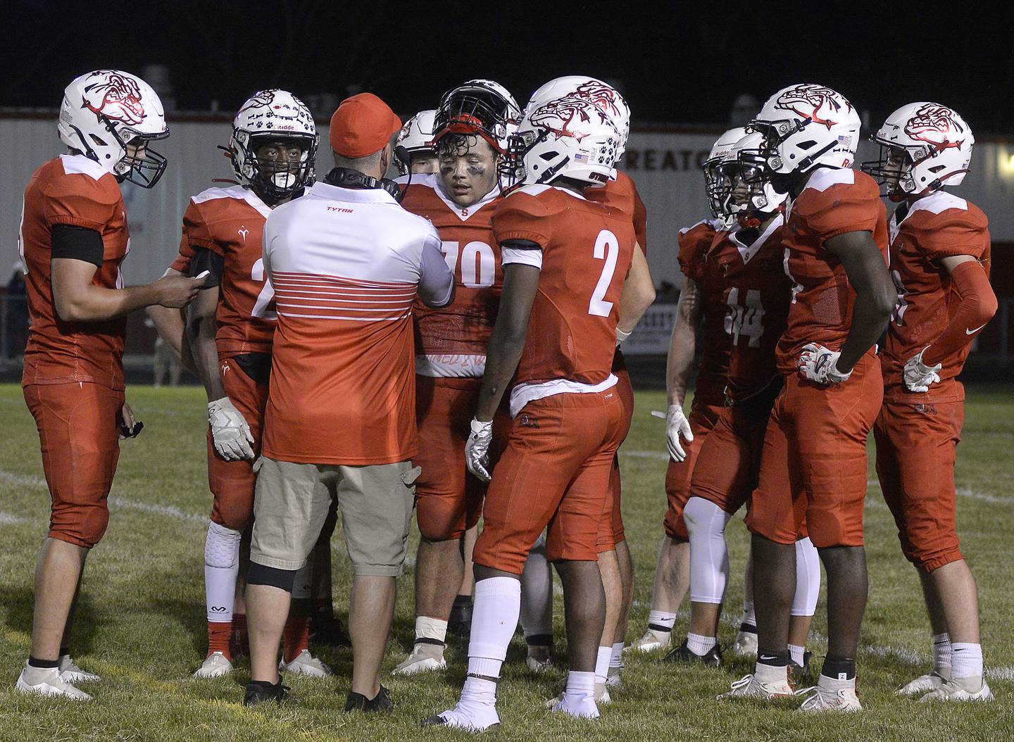 Members of the Streator football team discuss a plan after Lisle scored their first touchdown and called a timeout to try a two- point conversion on Friday, Sept. 16, 2022 at Dieken Stadium in Streator.