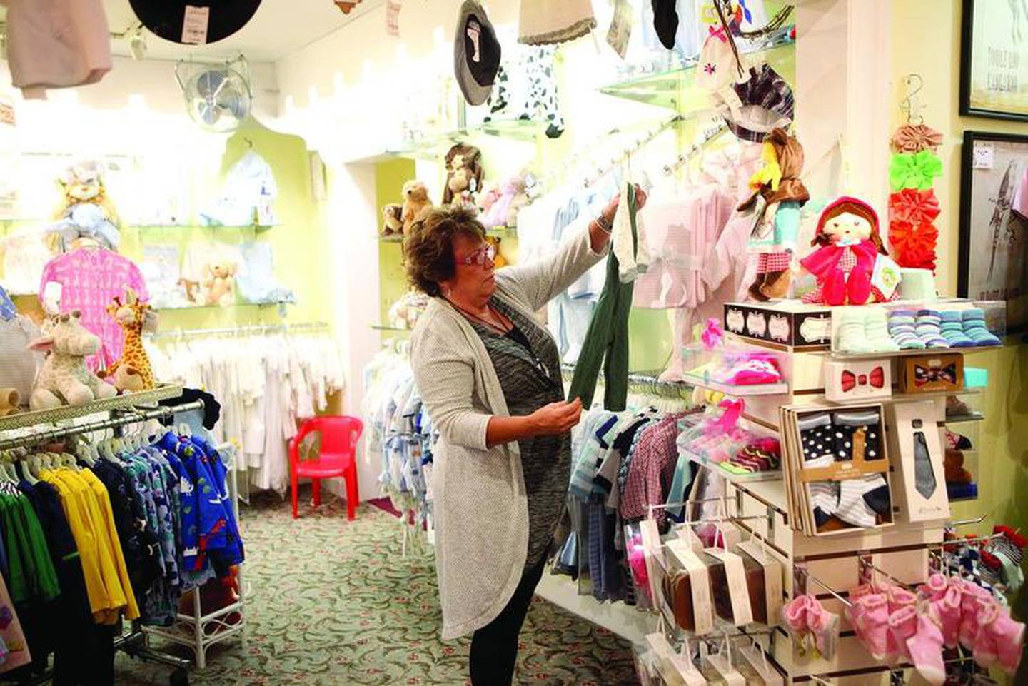 Marcie Lucas of West Chicago shops at The Little Traveler in Geneva. The Little Traveler on Third Street in downtown Geneva is 95 years old this year.