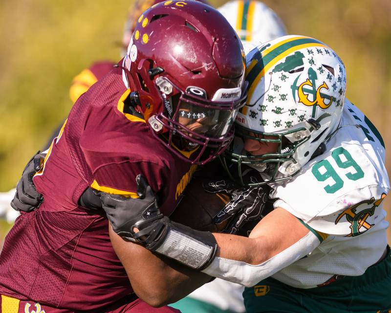 Coal City's Trace Wilson (99) tries to take down Montini Catholic's Charles Flowers (15) during the 4A quarterfinals game on Saturday Nov. 15, 2025, held at Montini Catholic High School.