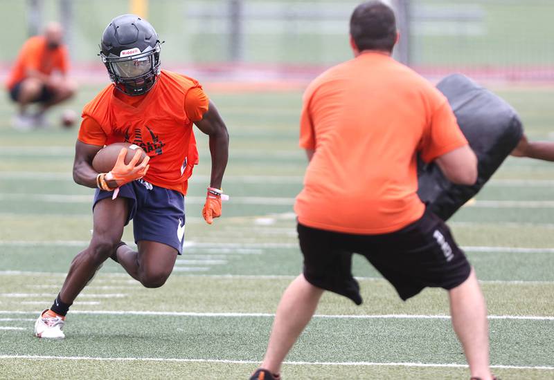 DeKalb's Jamari Brown carries the ball Monday, Aug. 8, 2022, at the school during their first practice ahead of the upcoming season.