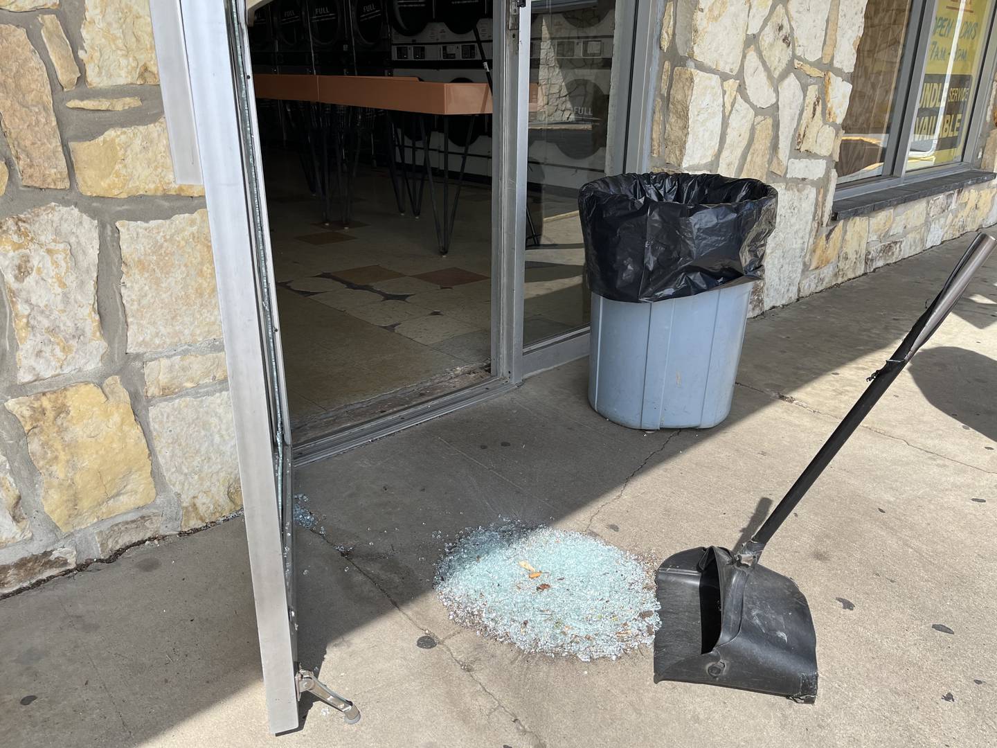 A pile of broke glass from gunfire damage at Splish Splash Laundromat, 1220 Richards St., seen on Thursday, April 18, in Joliet.