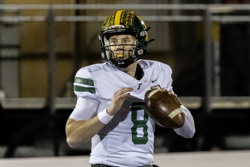 Fremd's Johnny O'Brien looks for an open teammate during an 8A varsity football playoff game against Bolingbrook at Bolingbrook on Nov. 15, 2025.