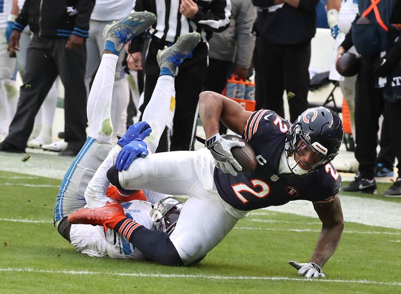 Chicago Bears wide receiver DJ Moore stretches for extra yardage as he is brought down by Detroit Lions safety Kerby Joseph during their game Sunday, Dec. 10, 2023 at Soldier Field in Chicago.