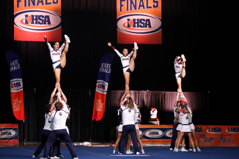 Members of the Oswego cheerleading team compete in the coed team division of the IHSA State Finals on Saturday, Feb. 8, 2025 at Grossinger Motors Arena in Bloomington.