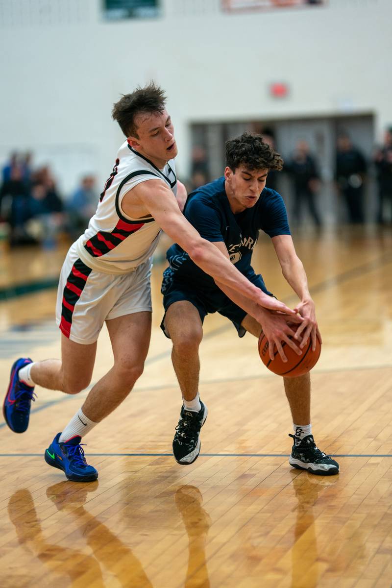 Benet’s Andy Nash (10) and Lake Park's Joshua Gerber (12) fight for a loose ball during a Bartlett 4A Sectional semifinal boys basketball game at Bartlett High School on Tuesday, Feb 28, 2023.