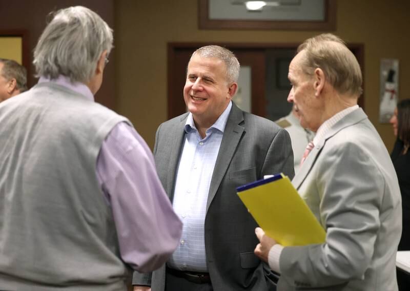 Current DeKalb Mayor Cohen Barnes, who is running for re-election, talks to former DeKalb Mayor Jerry Smith (left) and Second Ward Alderman candidate Michael Embrey (right) Wednesday, Feb. 19, 2025, during the DeKalb Area Rental Association and DeKalb Area Builders Association Candidate Night at Faranda's Banquet Center in DeKalb.