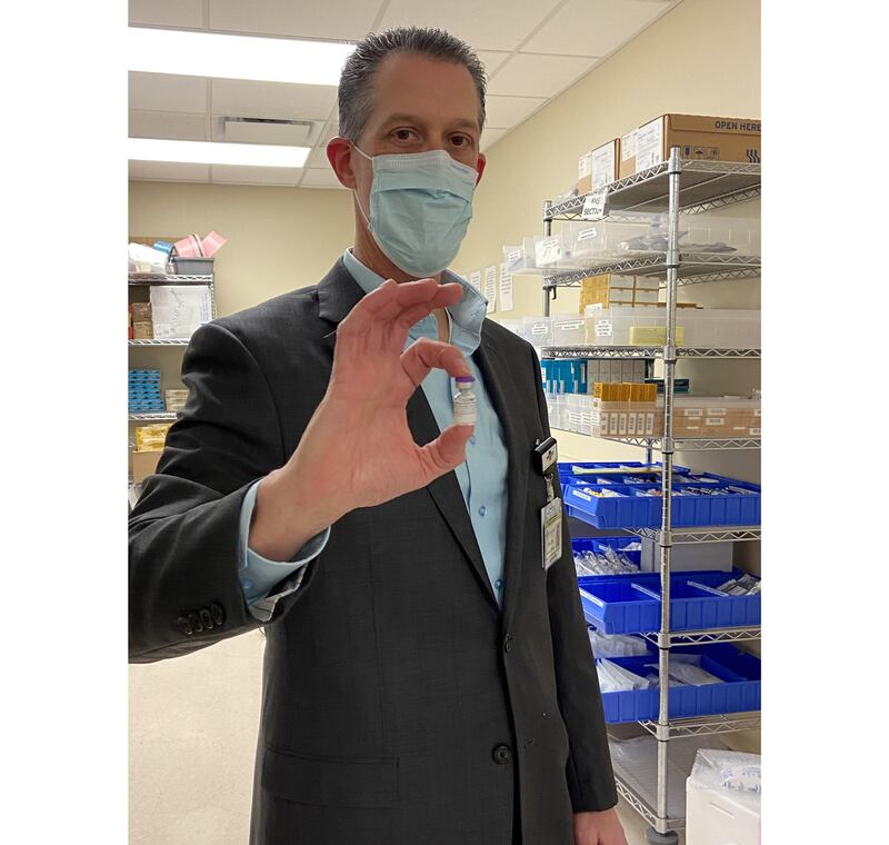 Frank Butler, administrative director of the pharmacy at Silver Cross Hospital in New Lenox, holds a vial of the Pfizer vaccine.