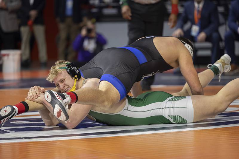 Coal City’s Cader Poyner works against Freeburg’s Dane Olmstead in the 215 pound class Saturday, Feb. 21, 2026, at the IHSA wrestling finals in Champaign.