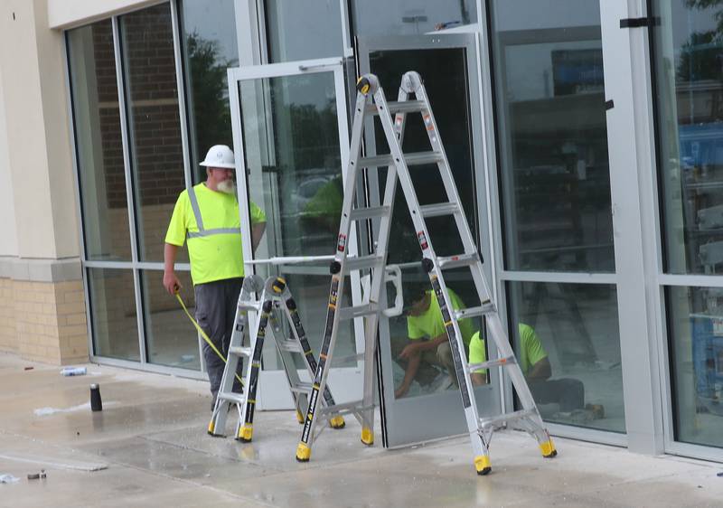 Crews install the front doors to the new Five Below store on Tuesday, July 8, 2025 between Kohl's and PetSmart in Peru. The 10,083 square foot building is starting to take shape. Five Below is a chain of specialty discount stores that prices most of its products at $5 or less with a smaller assortment of products priced up to $25.