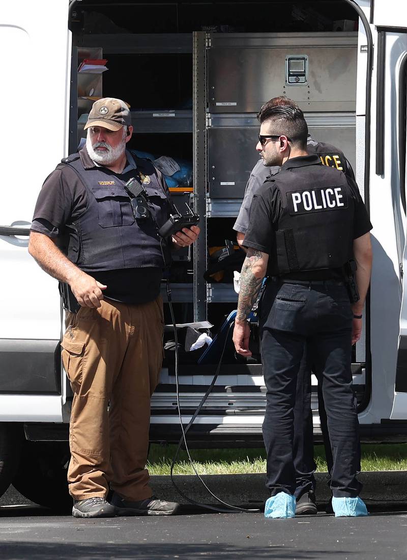 DeKalb Police officers work outside the Illinois Community Credit Union Wednesday, July 31, 2024, as they investigate a morning bank robbery in the facility at 1500 Barber Greene Road in DeKalb.