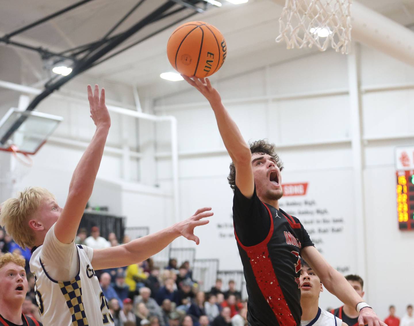 Indian Creek's Logan Schrader runs in for a layup against Marquette's Luke McCullough during the Class 1A Sectional game on Friday, March 6, 2026 at Amboy High School.