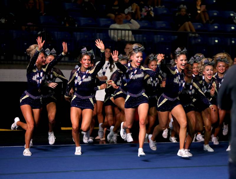 Members of the Lemont cheerleading team celebrate their first-place finish in the medium team division of the IHSA State Finals on Saturday, Feb. 8, 2025 at Grossinger Motors Arena in Bloomington.