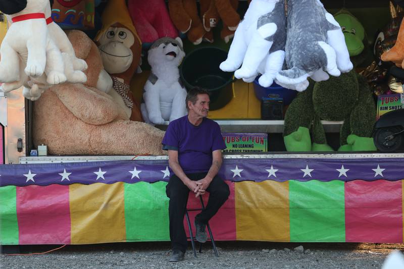 A carnival worker takes advantage of a down time at Lockport’s Canal Days on Friday, June 9, 2023.