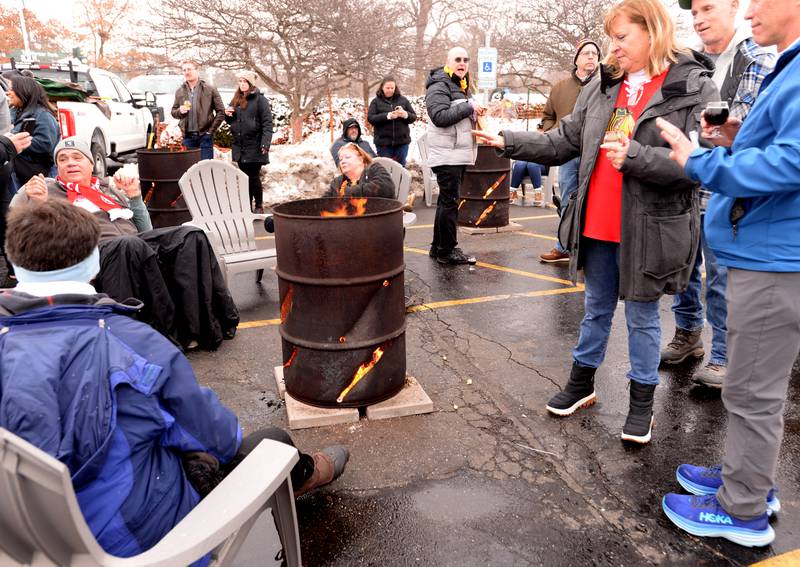 People including Michelle Fordyma of Burr Ridge enjoy the bonfire while attending the Westmont Park District's Winter Beer Festival Saturday, Feb. 15, 2025.
