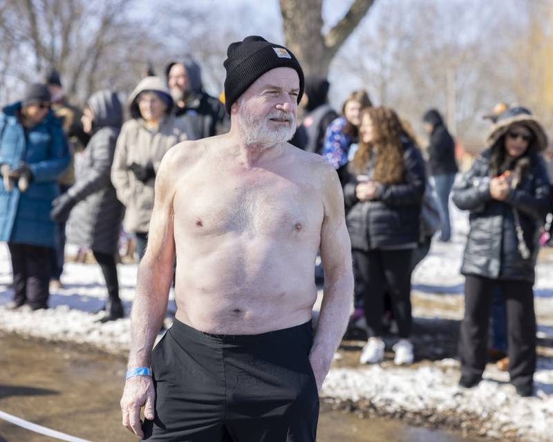 The first plunger of the day awaits the signal to make the jump into the frigid water during the Polar Plunge for Special Olympics on February 22, 2025 at Lake Mendota.