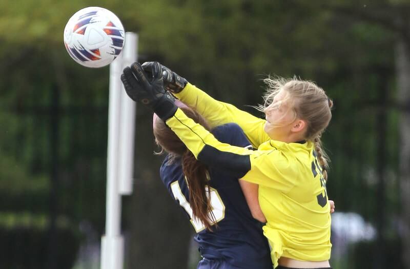 IC Catholic Prep's Allie Geiger collides with Pleasant Plains' goalie Elle Walker during the IHSA Class 1A state girls soccer third place game Saturday, May 27, 2023, at North Central College in Naperville.