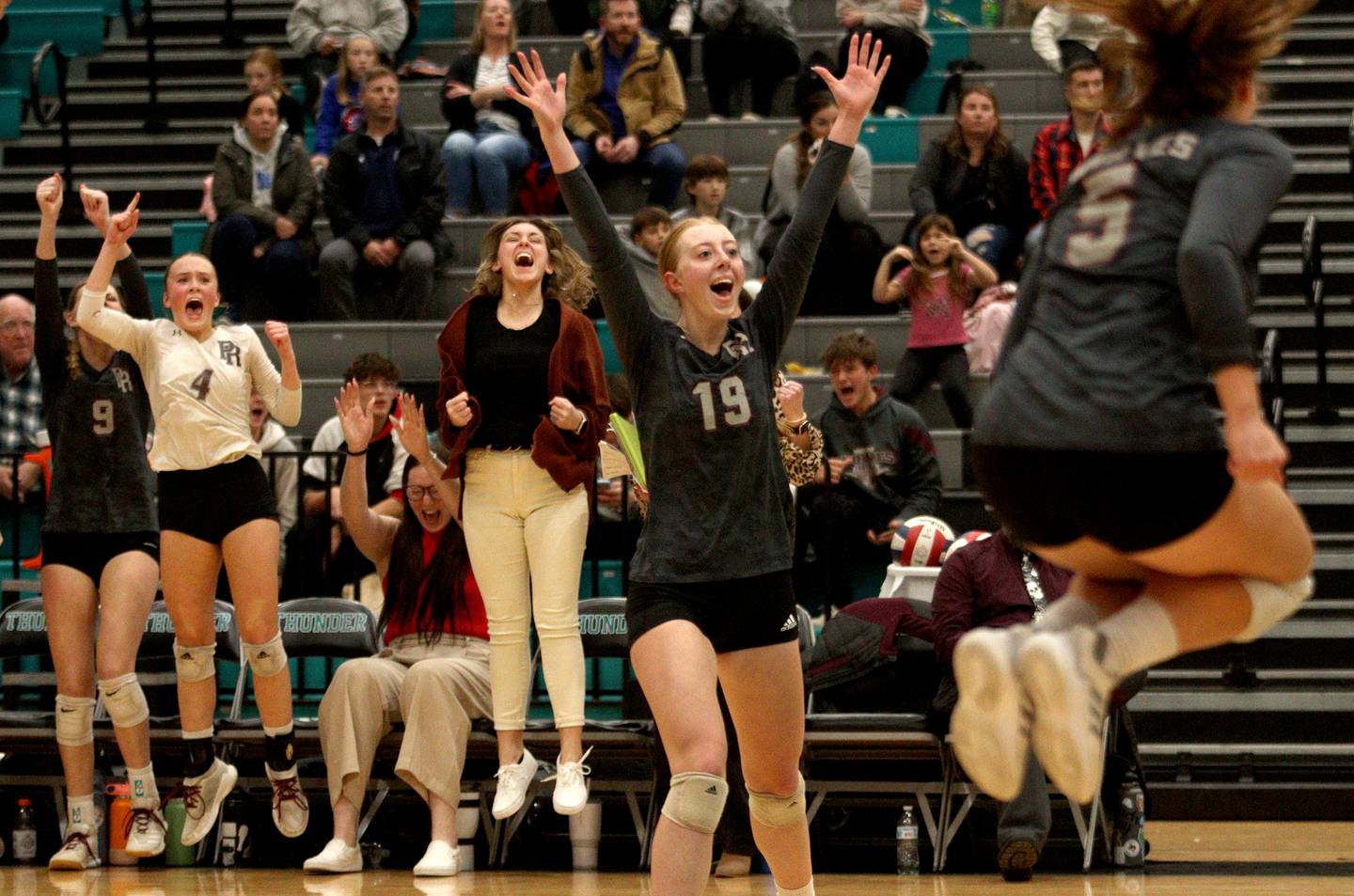 Prairie Ridge’s Ashley Stiefer (19) and the Wolves erupt late in a win over Woodstock in IHSA Class 3A sectional semifinal volleyball action at Woodstock North Monday.