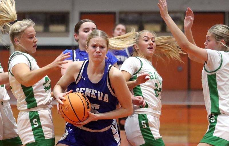 Geneva’s Emma Peterson, center, lands with a rebound against Crystal Lake South in girls IHSA Class 3A Sectional Championship basketball on Thursday, Feb. 26, 2026, at Crystal Lake Central High School in Crystal Lake.