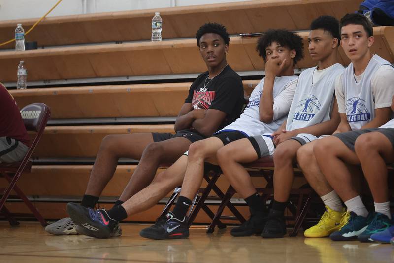 Joliet Central’s Danny Thompson, left, sits out the game against DeKalb at the 37th Morris Boys Shootout on Tuesday, June 25, 2024.