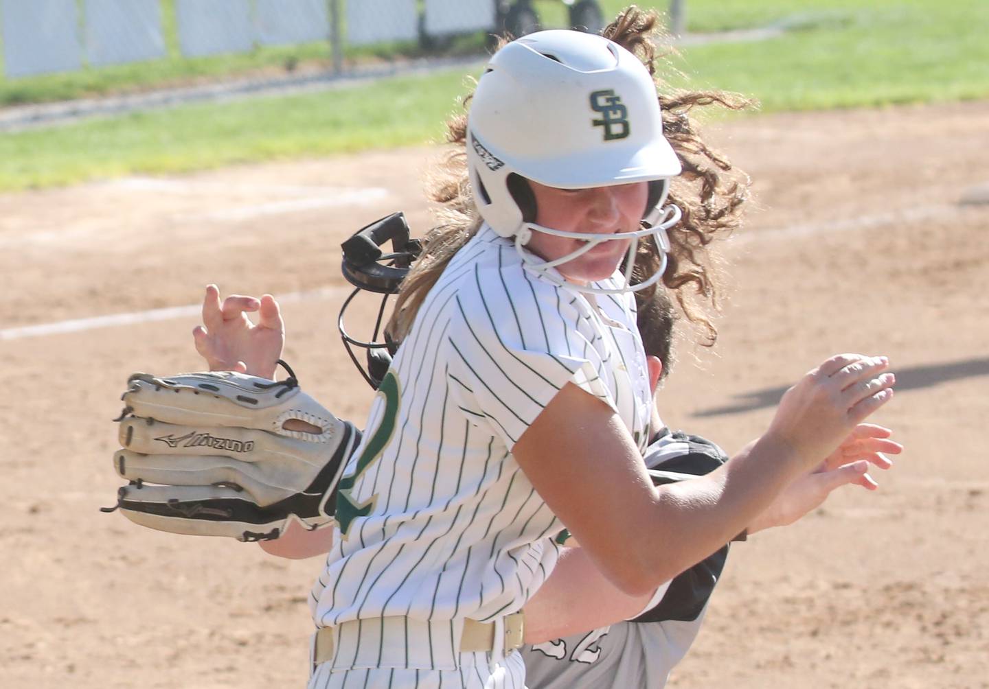 St. Bede's Ella Hermes collides with Woodland/Flanagan-Cornell's Kaylee Henert while running to first base on Monday, April 29, 2024 at St. Bede Academy.