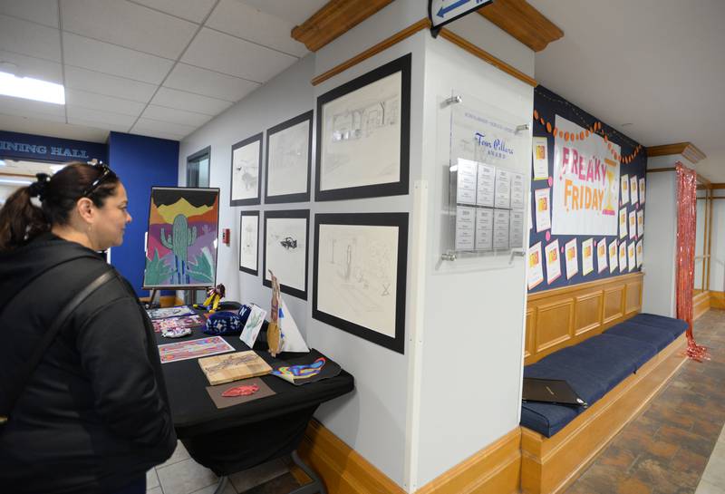 Nazareth parents including Monica Espinosa of Stickney  look at students art work created by all the art classes during the Expressive Arts Showcase held Monday, April 8, 2024.
