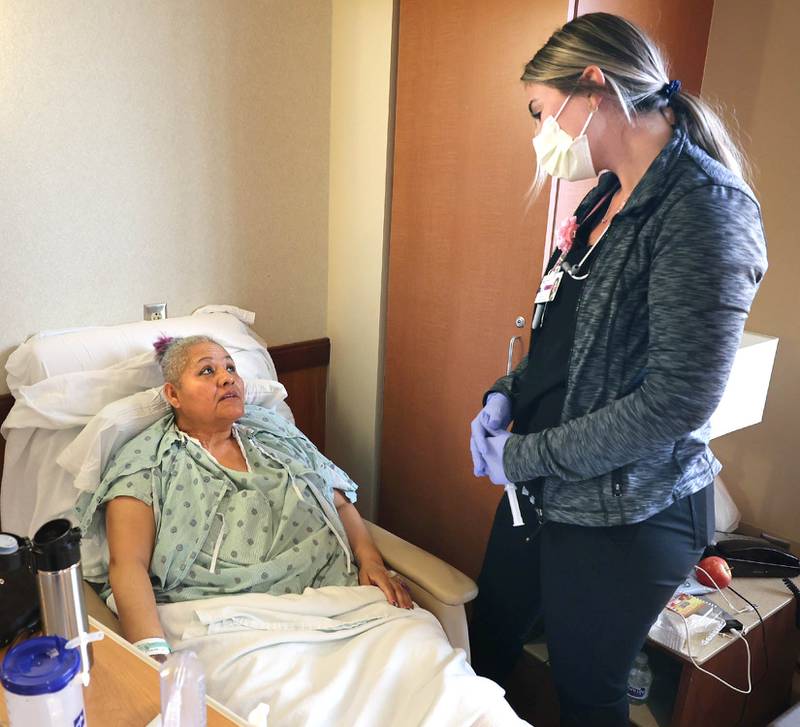 Travel nurse Alexandra Pop talks to patient Maria Gallardo, of DeKalb, Wednesday, March 23, 2022, at Northwestern Medicine Kishwaukee Hospital in DeKalb.