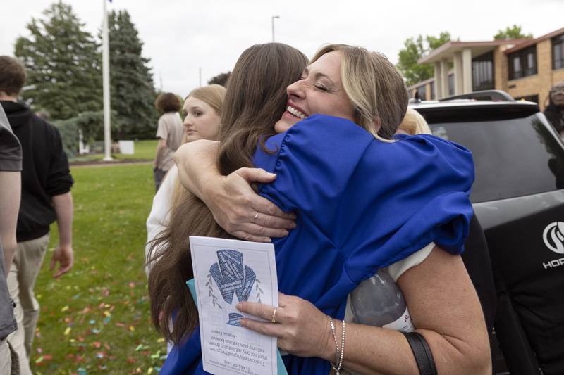 Stephanie Clark hugs daughter Olivia Wednesday, May 21, 2025, following graduation at Newman High School.