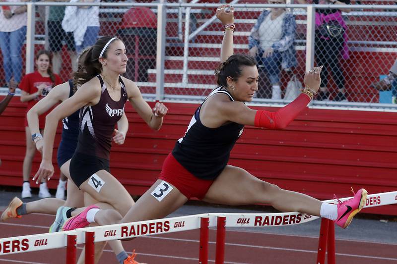 Huntley's Sophie Amin hits the hurdle as she is chased by Prairie Ridge's Rylee Lydon in the 100 meter hurdles Friday, May 10, 2023, during the IHSA Class 3A Huntley Girls Track and Field Sectional at Huntley High School.