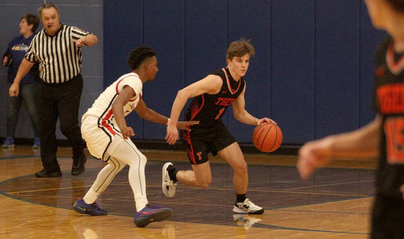 Crystal Lake Central’s Drew Welder moves the ball past Huntley’s Bryce Walker during tournament basketball action at Johnsburg High School Monday evening.