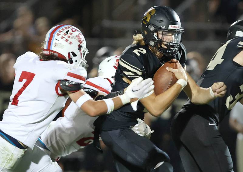 Sycamore's Elijah Meier tries to break the tackle of Ottawa's Dillan Quatrano during their game Friday, Sept. 16, 2022, at Sycamore High School.