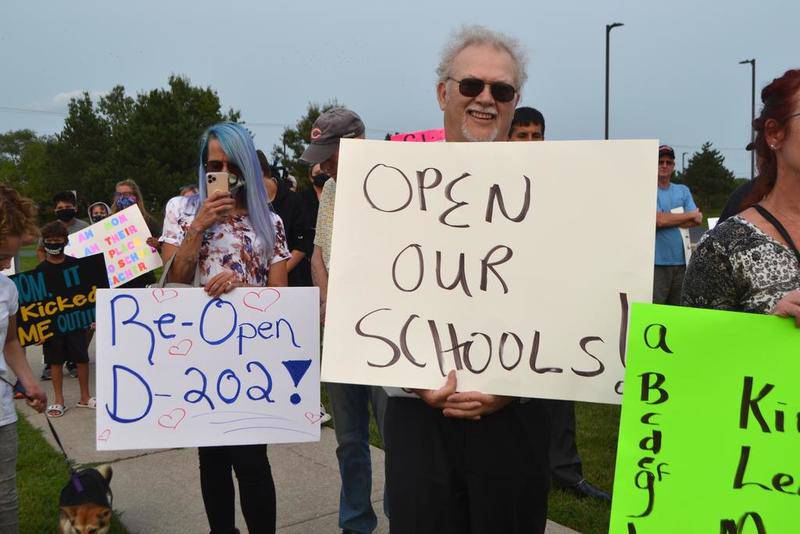 Dozens of parents gathered Sept. 14 at a rally to demand that Plainfield Community Consolidated School District 202 resume in-person learning during the COVID-19 pandemic.