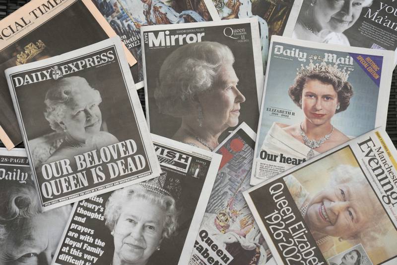 Newspapers devoted to the death of Queen Elizabeth II are seen in Manchester, England, Friday, Sept. 9, 2022. Queen Elizabeth II, Britain's longest-reigning monarch, died on Thursday Sept. 8 aged 96. (AP Photo/Jon Super)