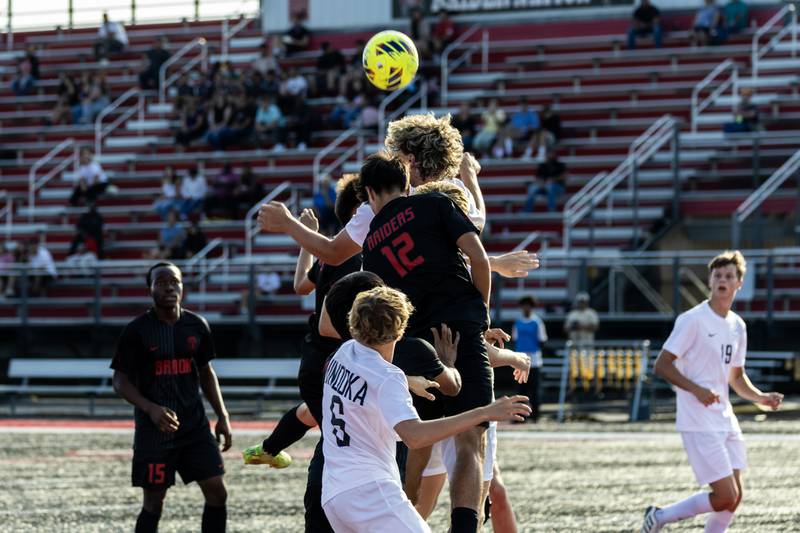 Minooka and Bolingbrook players collide during a varsity soccer game in Bolingbrook on Sept. 16, 2025.