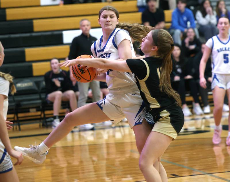 Burlington Central's Scarlett LaFleur pulls down a rebound in front of Sycamore's Cortni Kruizenga Thursday, Feb. 19, 2026, during their Class 3A regional championship game at Sycamore High School.