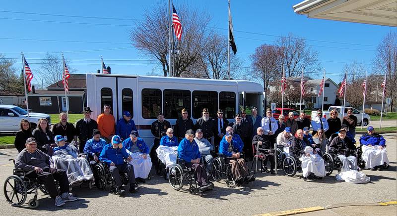 Residents of the Illinois Veterans Home in La Salle celebrate the gift of a new shuttlebus on Saturday morning.