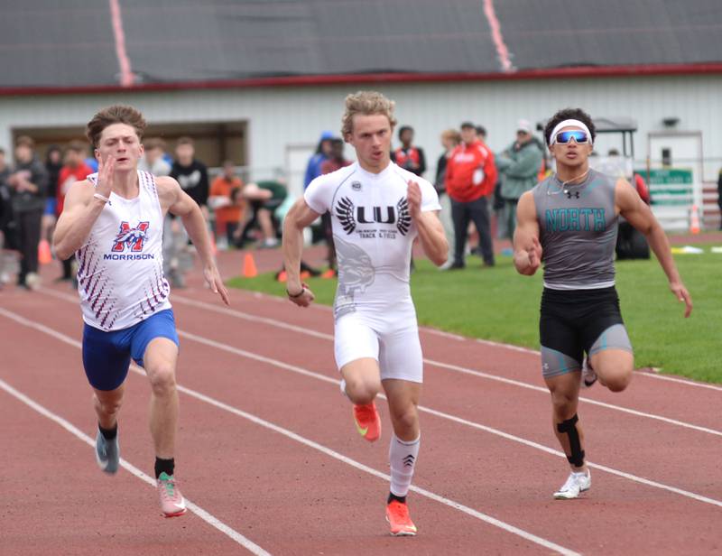 Morrison's Levi Milder (left) races Lena-Winslow's Alec Schlichting (center) and Rockford Lutheran's David Ballard (right) to the finish line in the 100 meters at the Hawk Classic on Friday, May 2, 2025 at Landers-Loomis Field in Oregon. Schlichting won the race in 10.99 seconds, Milder was second in 11.09 and Ballard was third in 11.29.