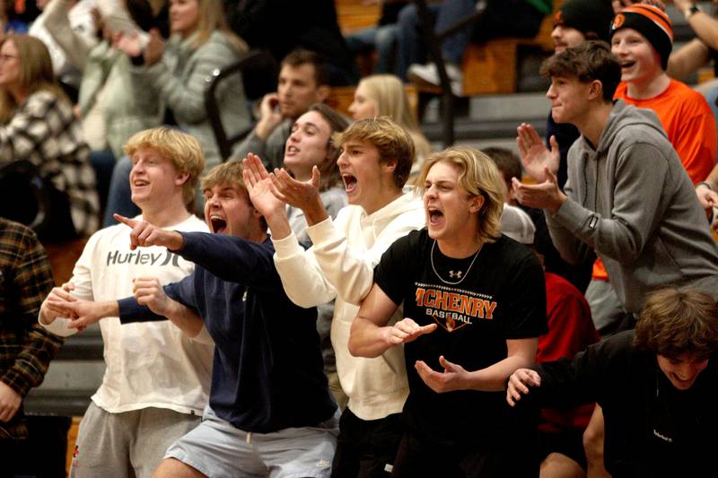 McHenry’s fans get revved up as the Warriors build a large first-half lead over Kaneland in Hoops for Healing basketball tournament championship game action at Woodstock Wednesday.
