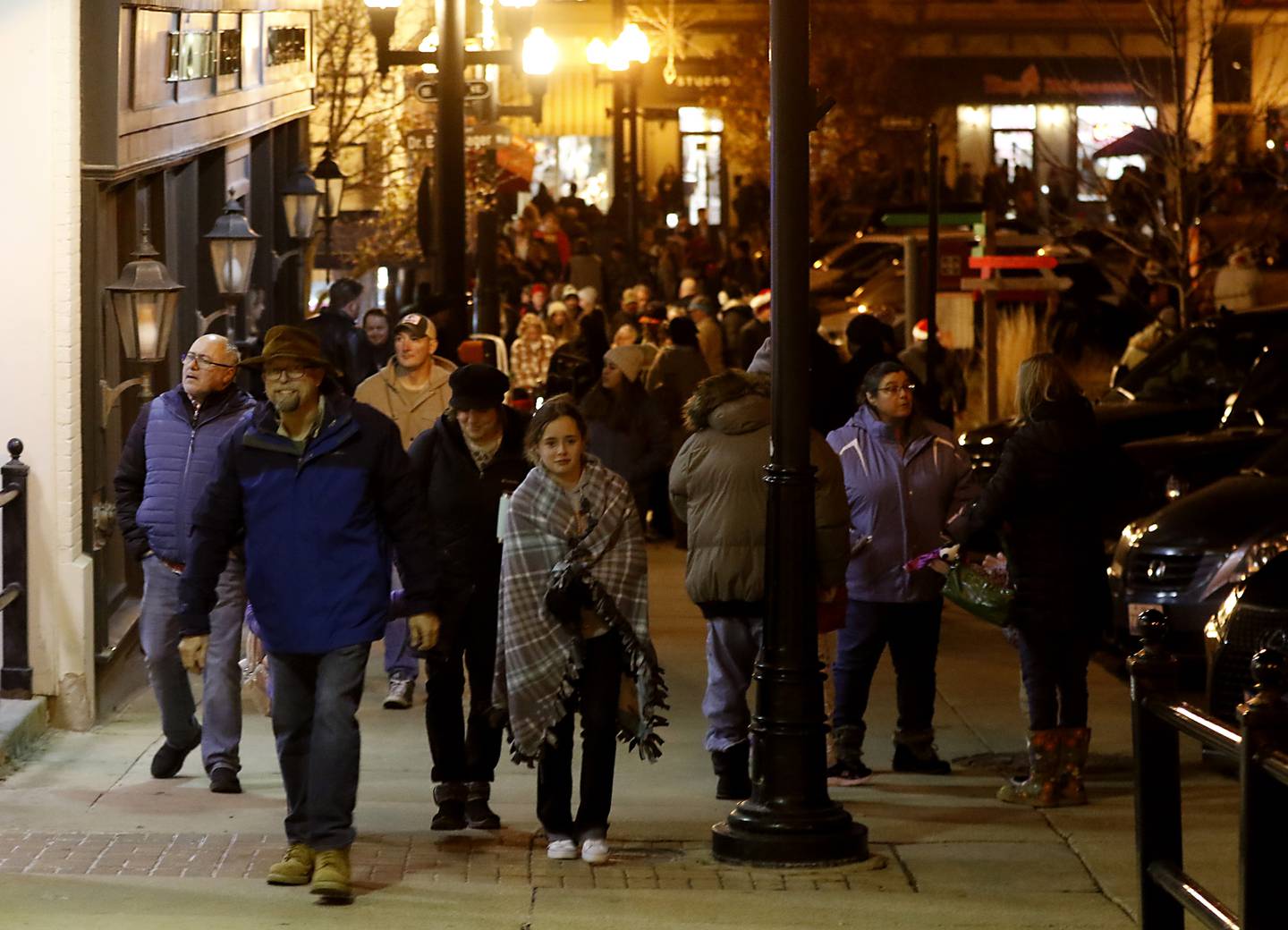 People walk around the Square during the Lighting of the Square Friday, Nov. 25, 2022, in Woodstock. The annual event featured brass music, caroling, free doughnuts and cider, food trucks, festive selfie stations and shopping