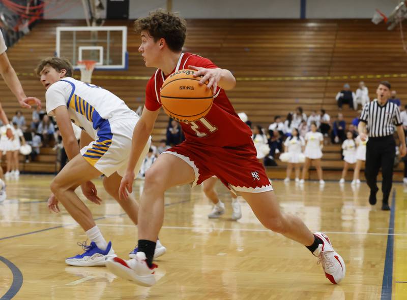 Hinsdale Central's Justin Kurkowski (21) dribbles during a varsity basketball game between Hinsdale Central and Lyons Township high schools on Friday, Dec. 12, 2025 in La Grange.