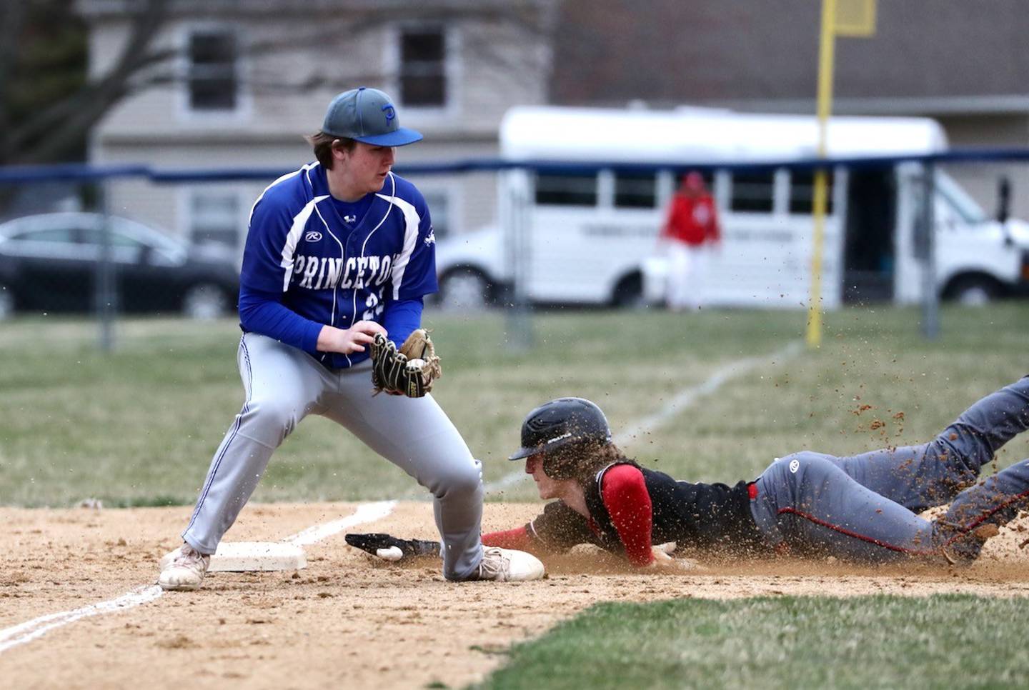 Hall's Mac Resetich slides in safely ahead of the throw to Princeton third baseman Jordan Reinhardt for a stolen base Monday at Prather Field.